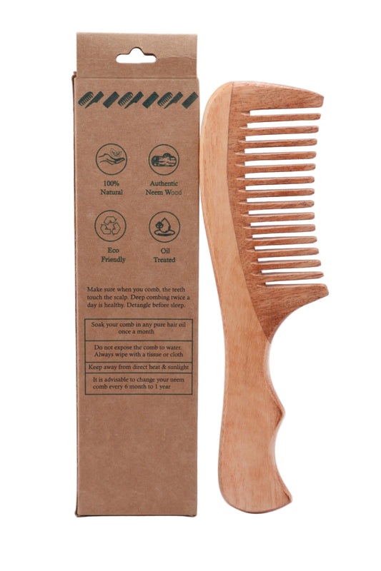 Fruzzona Fanch neem wood comb held in hand showing wide teeth